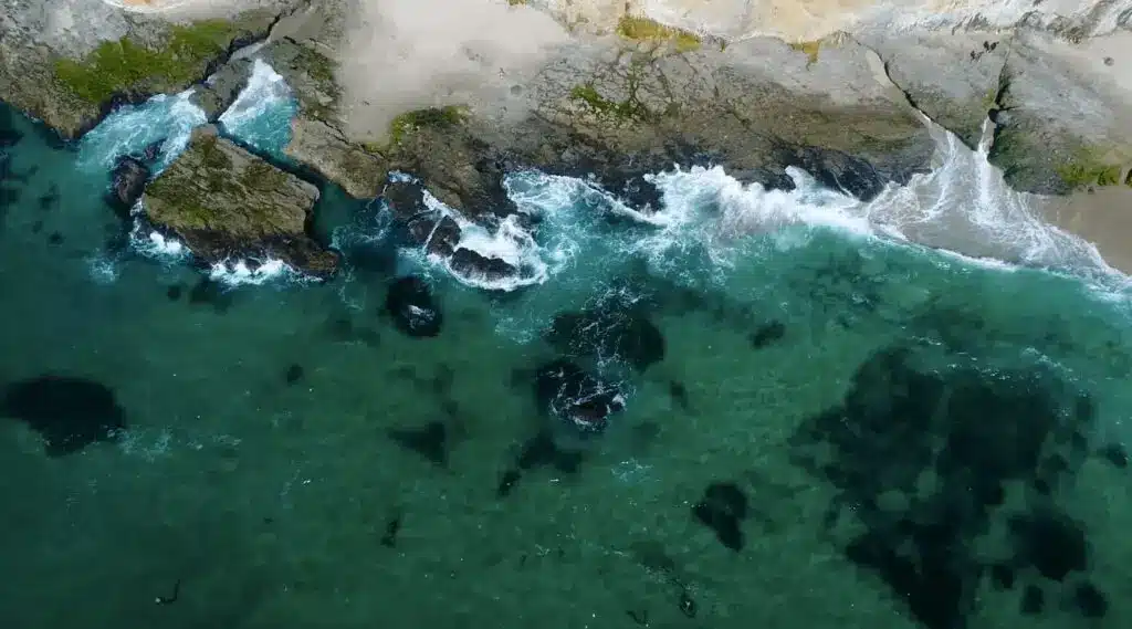 Aerial view of waves breaking over a rocky reef along the Laguna Beach coastline Aerial view of waves breaking over a rocky reef along the Laguna Beach coastline