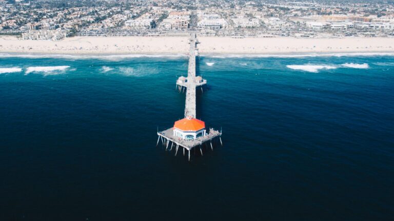 Aerial view of the Huntington Beach Pier and Surf City coastline at golden hour