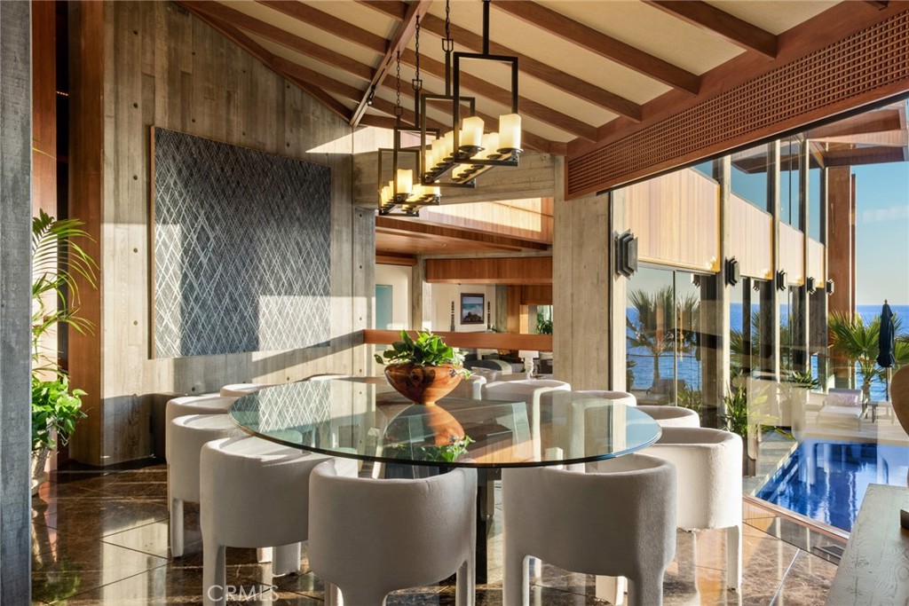 Dining room framed by walls of glass at 100 Rockledge Road, Laguna Beach Dining room framed by walls of glass at 100 Rockledge Road, Laguna Beach