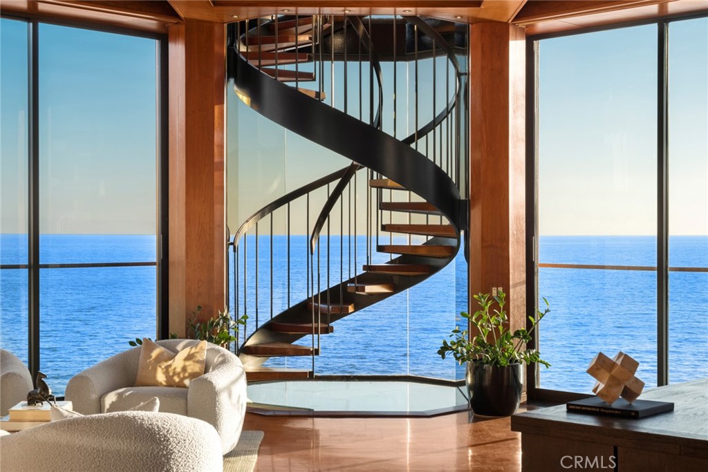 Sculptural spiral staircase against glass walls over the ocean at 100 Rockledge Road, Laguna Beach Sculptural spiral staircase against glass walls over the ocean at 100 Rockledge Road, Laguna Beach