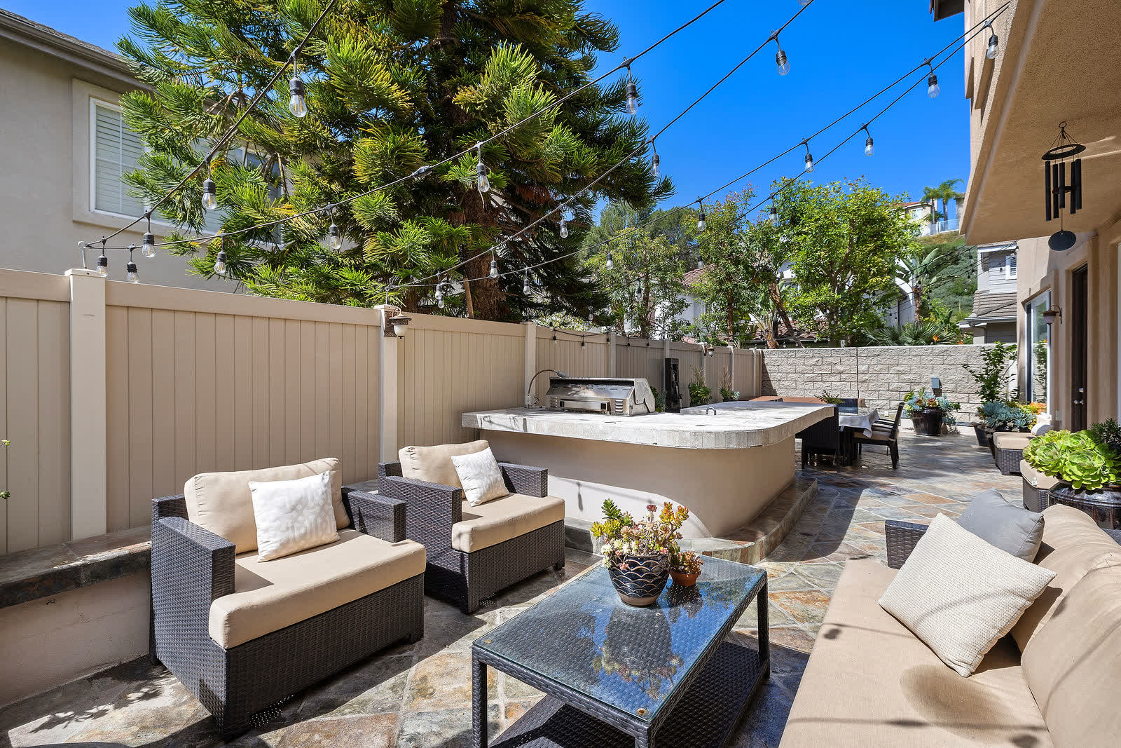 Backyard lounge seating under string lights at 5 Lyon Ridge, Aliso Viejo