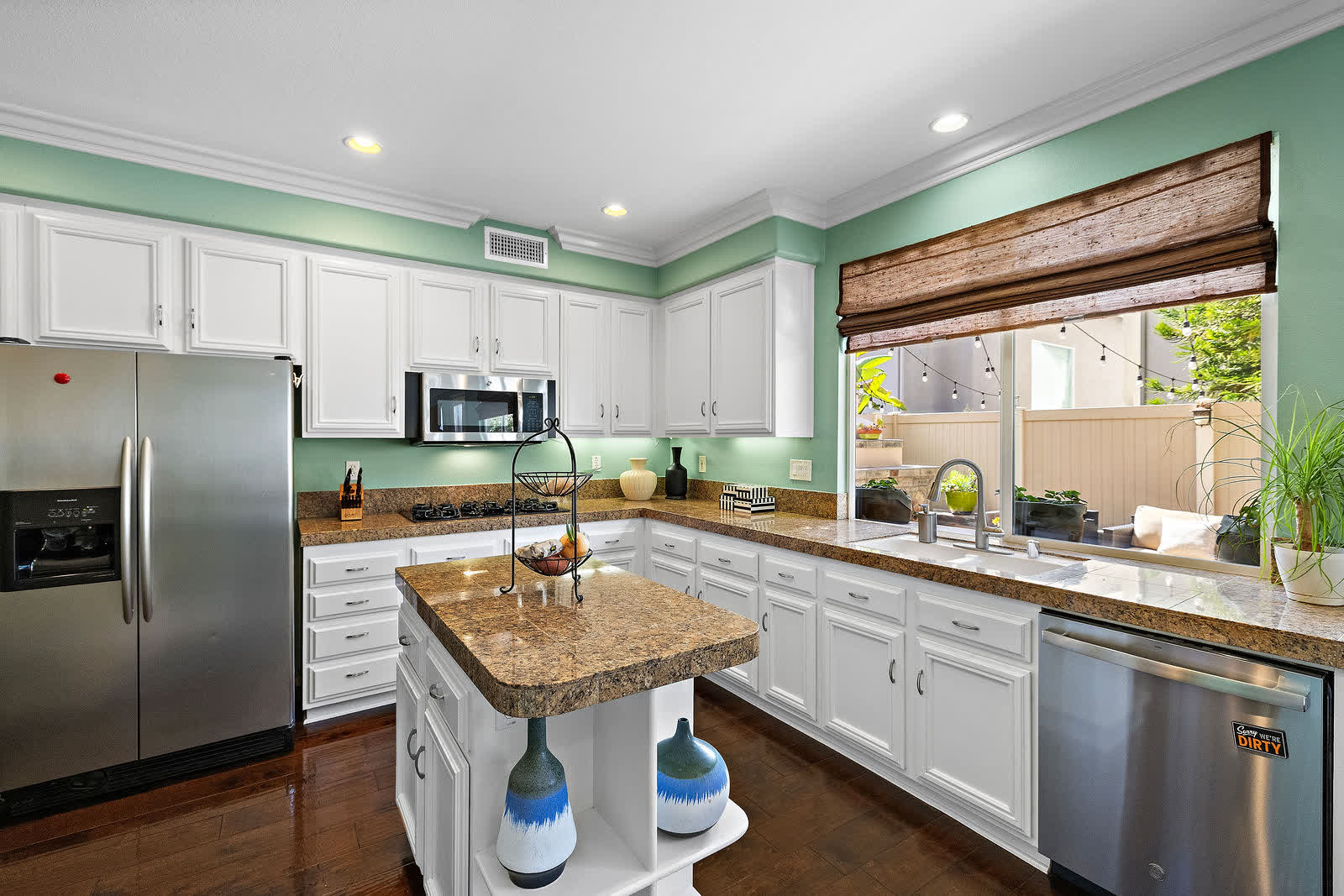 Kitchen with granite counters, a center island, and stainless appliances at 5 Lyon Ridge, Aliso Viejo