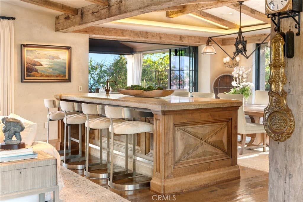 Kitchen island with stone counters and bar seating at 15 Montage Way, Laguna Beach Kitchen island with stone counters and bar seating at 15 Montage Way, Laguna Beach