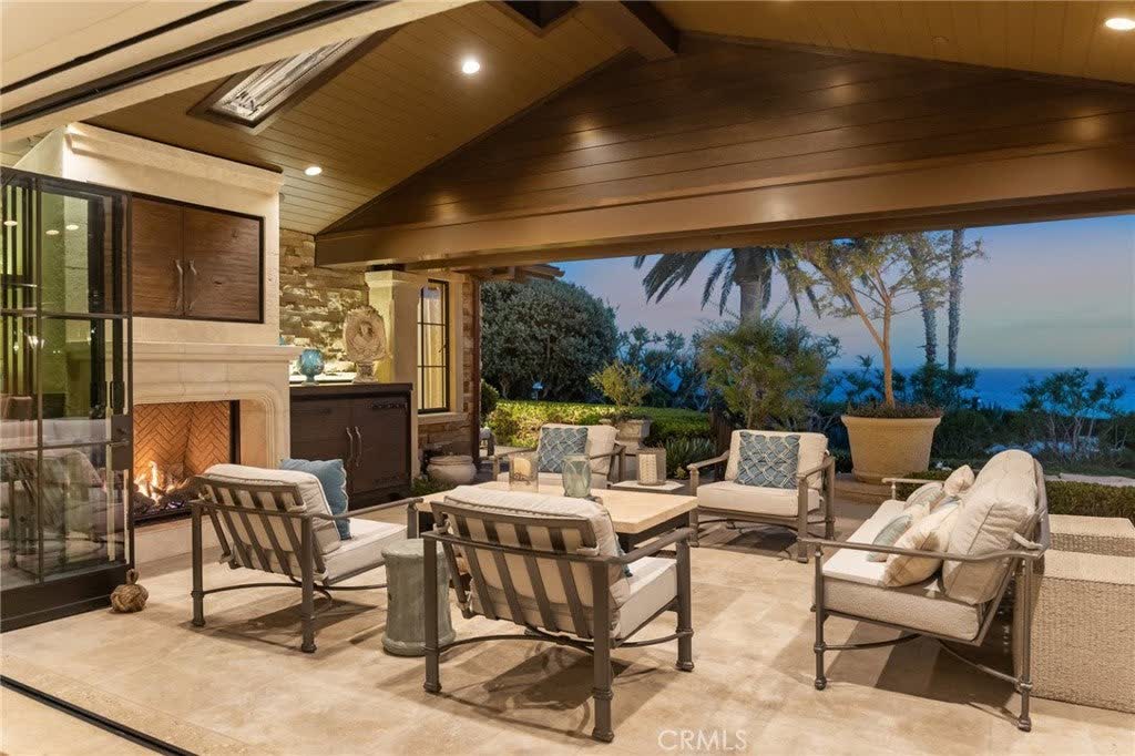 Outdoor fireplace and seating under cover at 15 Montage Way, Laguna Beach Outdoor fireplace and seating under cover at 15 Montage Way, Laguna Beach