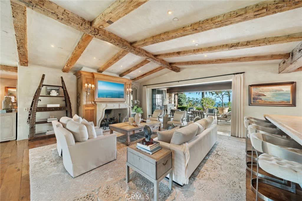 Living room with a fireplace and walls of glass to the Pacific at 15 Montage Way, Laguna Beach Living room with a fireplace and walls of glass to the Pacific at 15 Montage Way, Laguna Beach