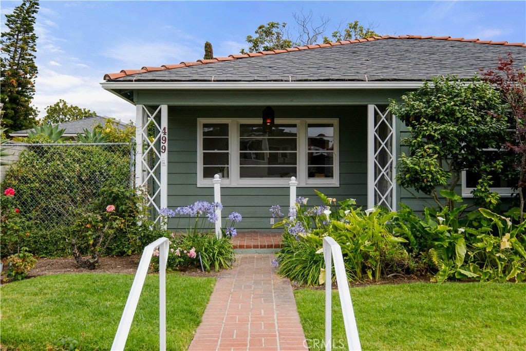 Front elevation of the green 1947 cottage with lattice porch posts at 499 Legion Street at 499 Legion, Laguna Beach Front elevation of the green 1947 cottage with lattice porch posts at 499 Legion Street at 499 Legion, Laguna Beach