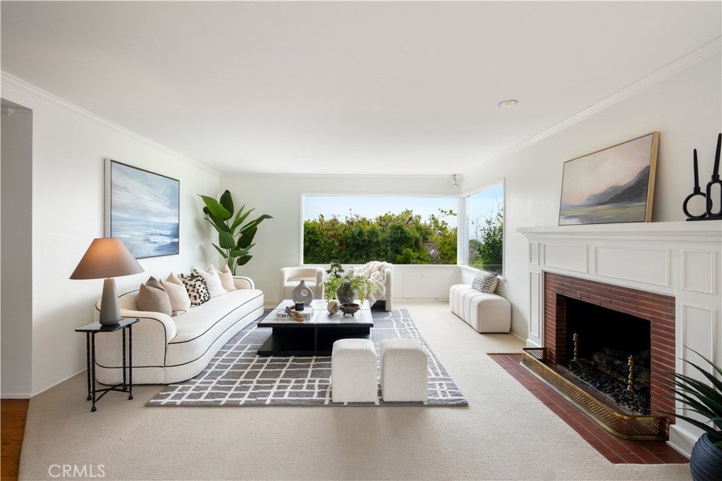 Living room with a brick fireplace and wood floors at 499 Legion, Laguna Beach Living room with a brick fireplace and wood floors at 499 Legion, Laguna Beach