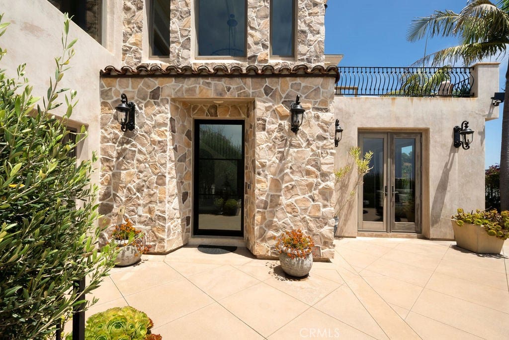 Stone entry and courtyard doors at 740 Bolsana Drive, Laguna Beach
