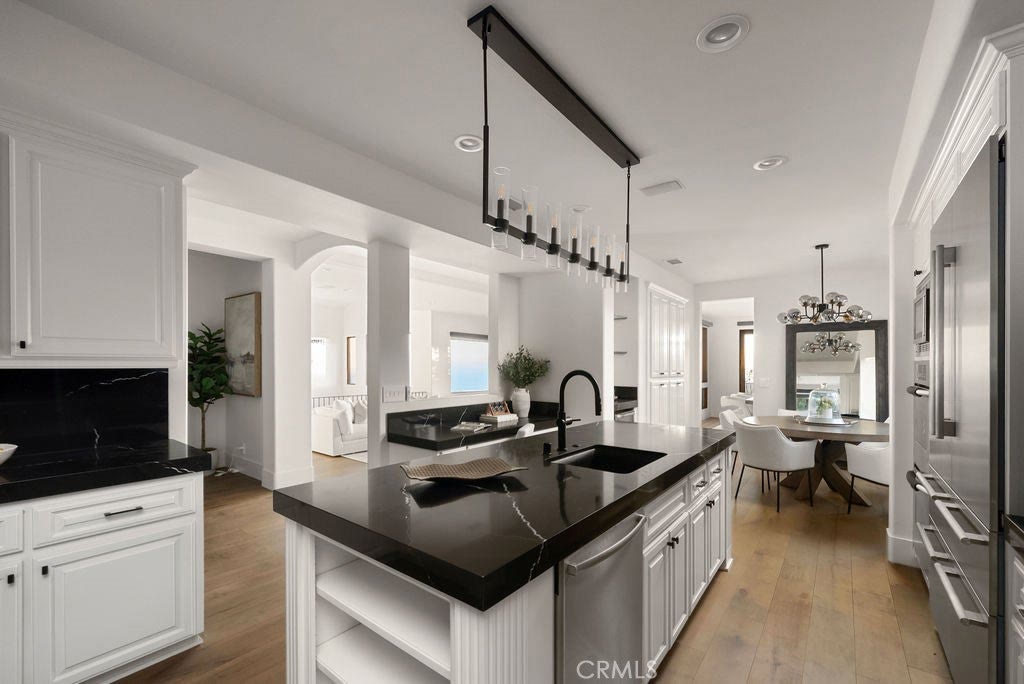 Kitchen with stone counters and built-in range at 740 Bolsana Drive, Laguna Beach