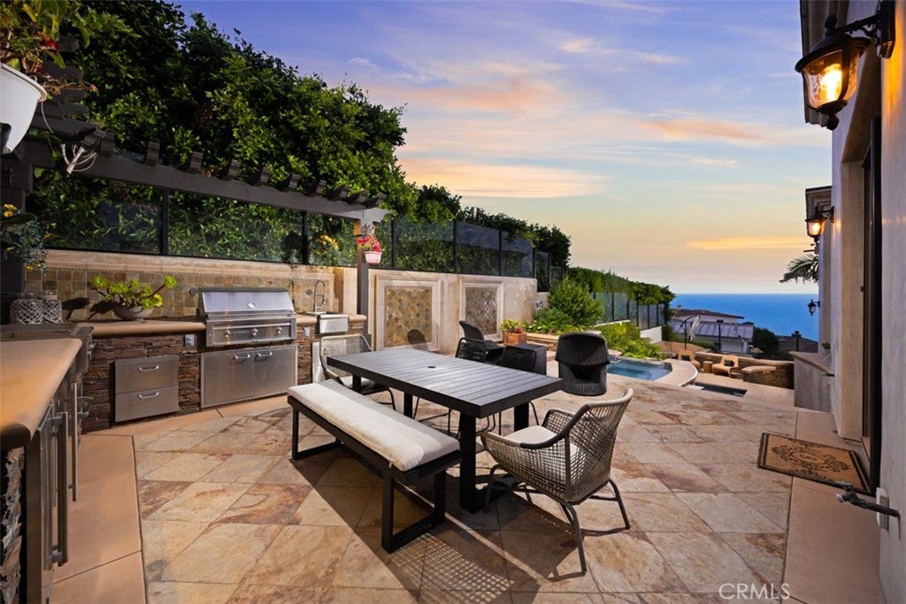 Built-in outdoor kitchen and dining terrace at 740 Bolsana Drive, Laguna Beach