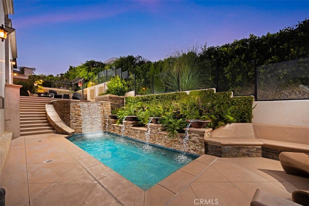 Heated pool with waterfall at twilight at 740 Bolsana Drive, Laguna Beach