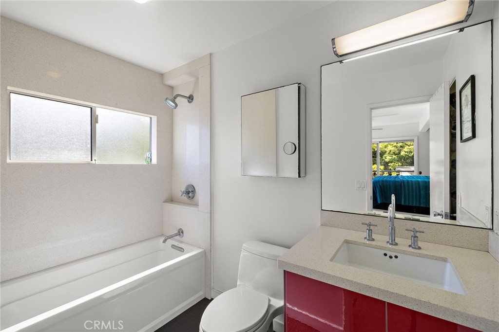Bathroom with a tub and a red vanity at 888 Summit Drive, Laguna Beach