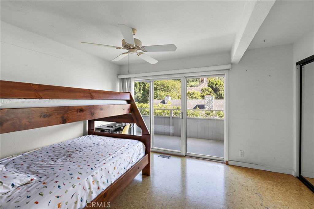 Bedroom with sliding doors to a deck at 888 Summit Drive, Laguna Beach