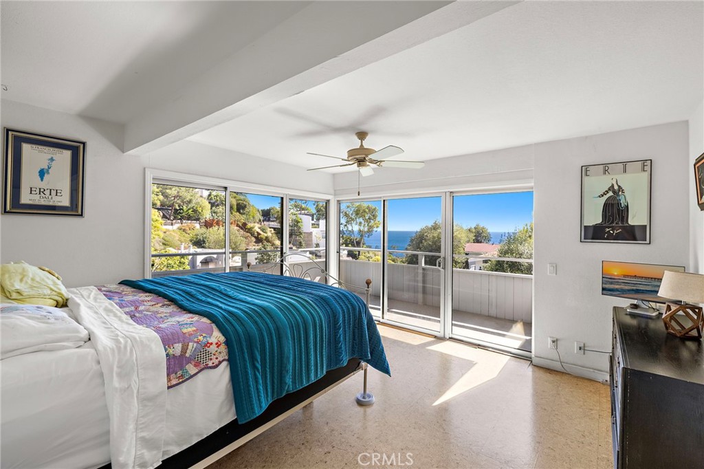 Bedroom with sliding doors to a deck and an ocean view at 888 Summit Drive, Laguna Beach