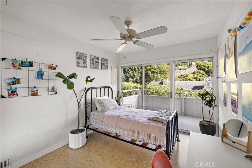 Bedroom with sliding doors to a deck at 888 Summit Drive, Laguna Beach