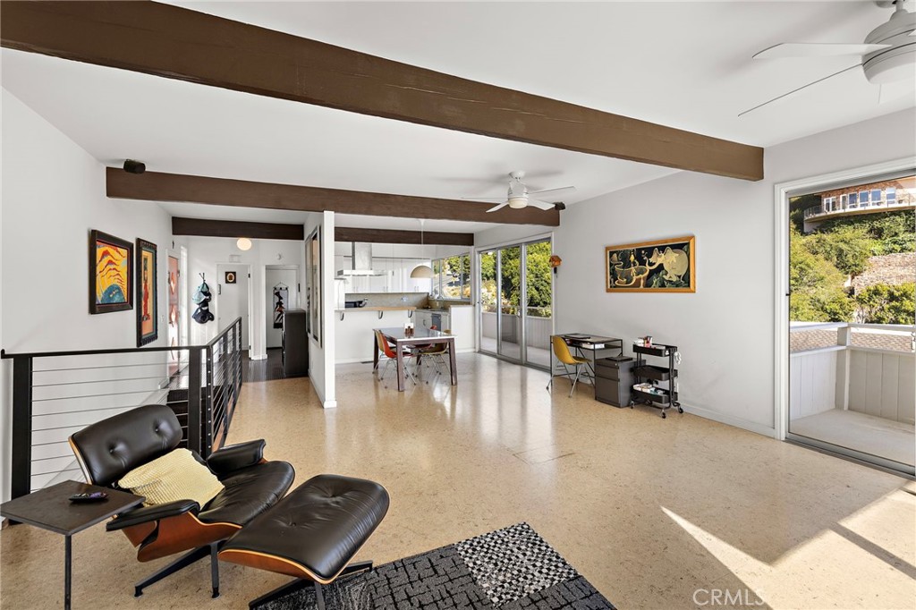 Great room toward the dining area and kitchen beside the stairs at 888 Summit Drive, Laguna Beach