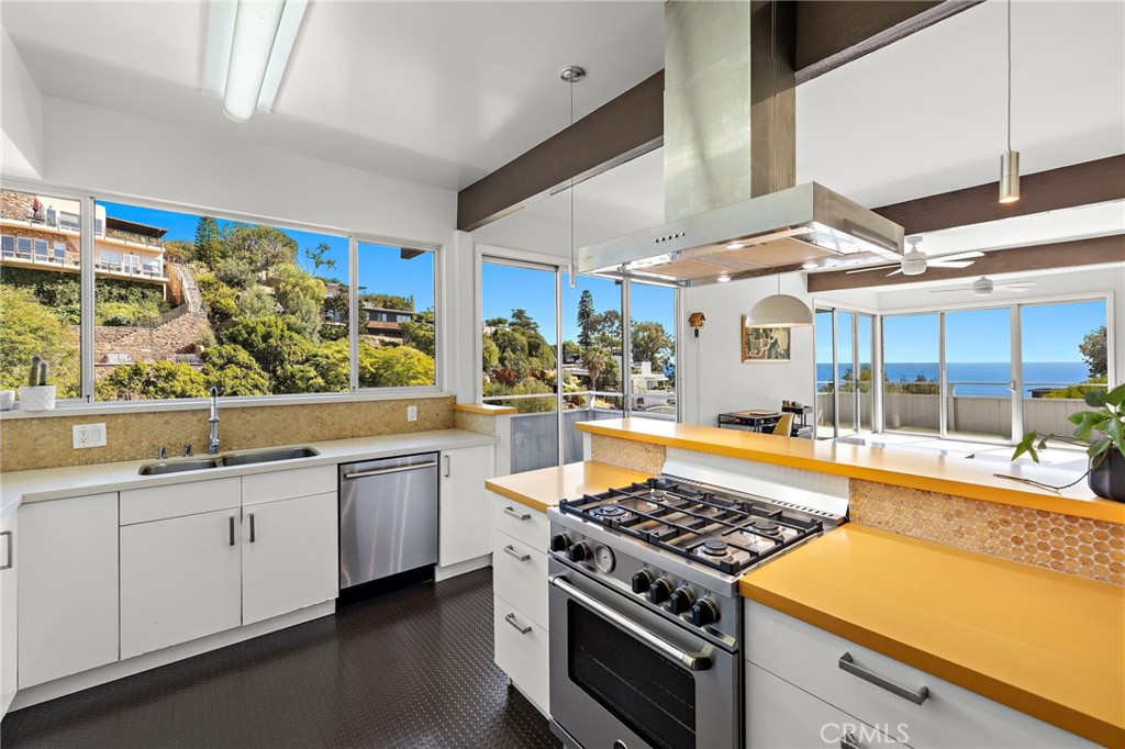 Kitchen with a gas range under a stainless hood at 888 Summit Drive, Laguna Beach