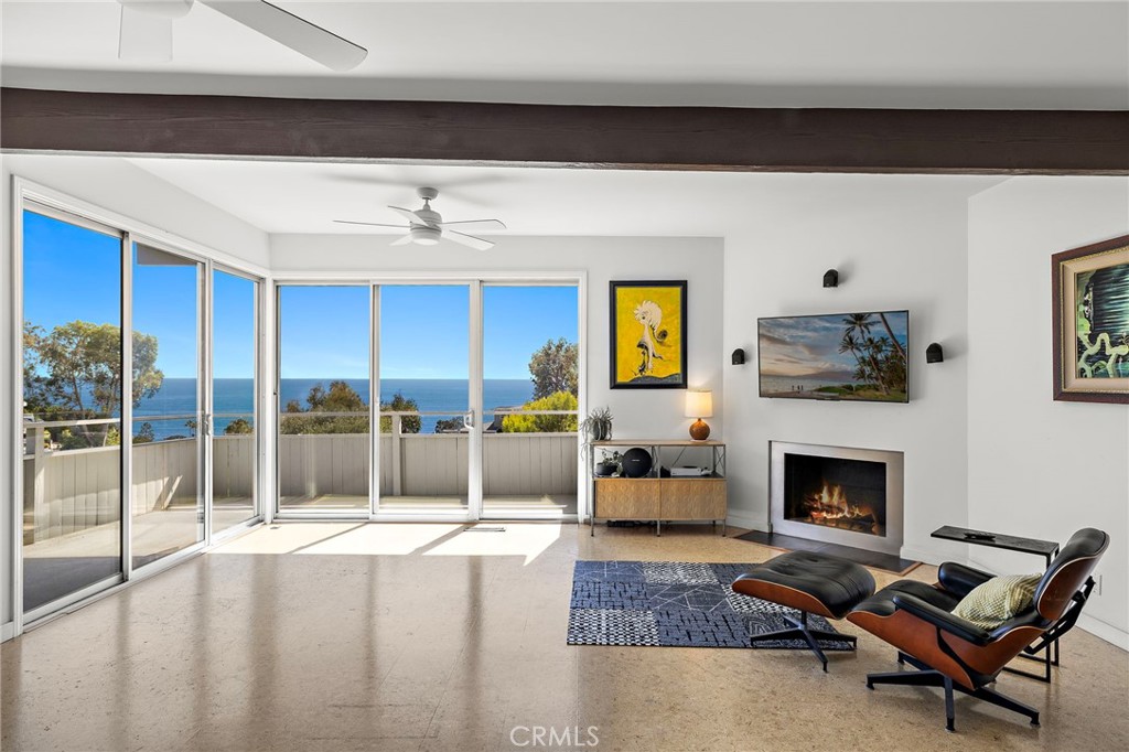 Living room with sliding glass doors facing the ocean at 888 Summit Drive, Laguna Beach